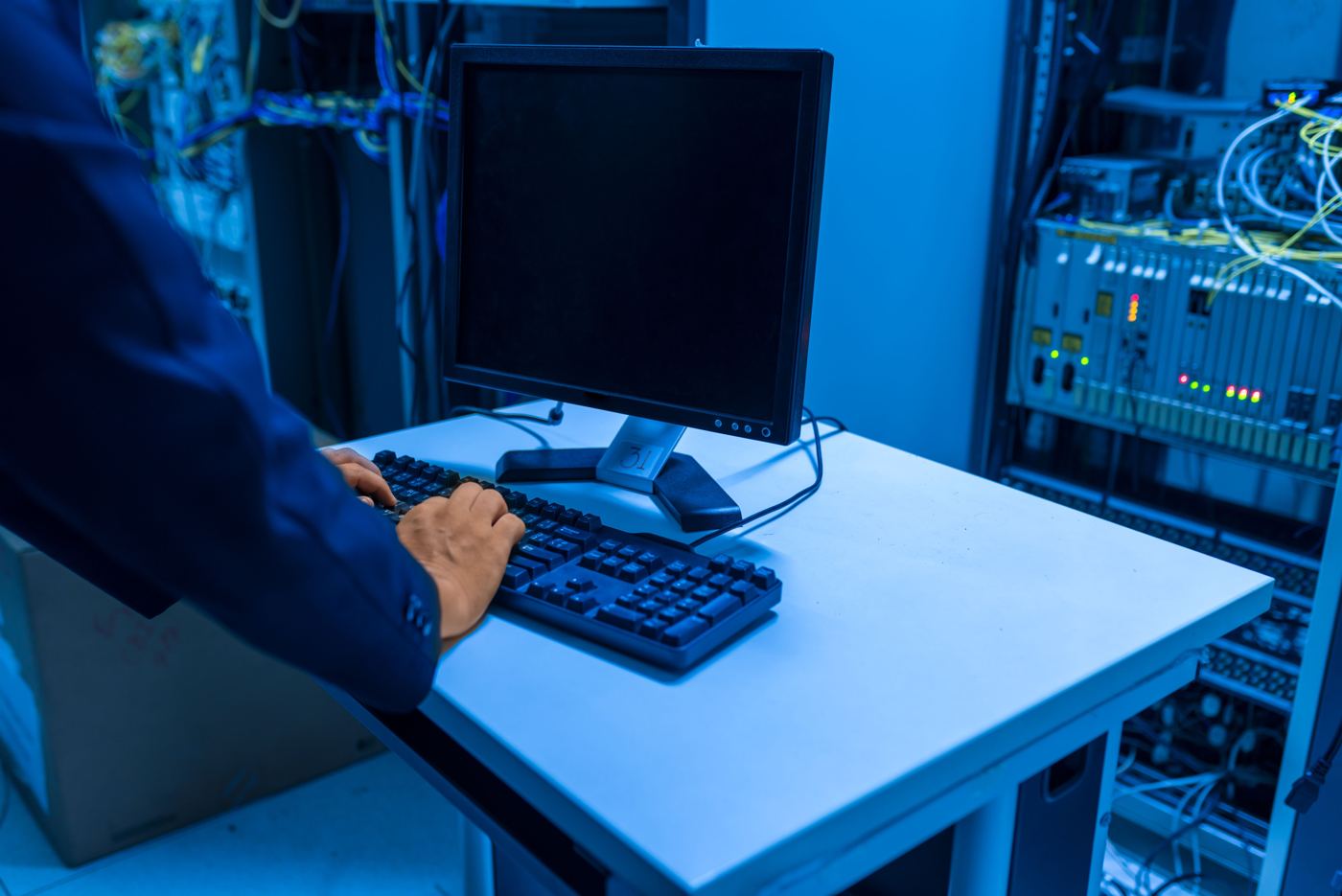 Technician working at a workstation in a server room